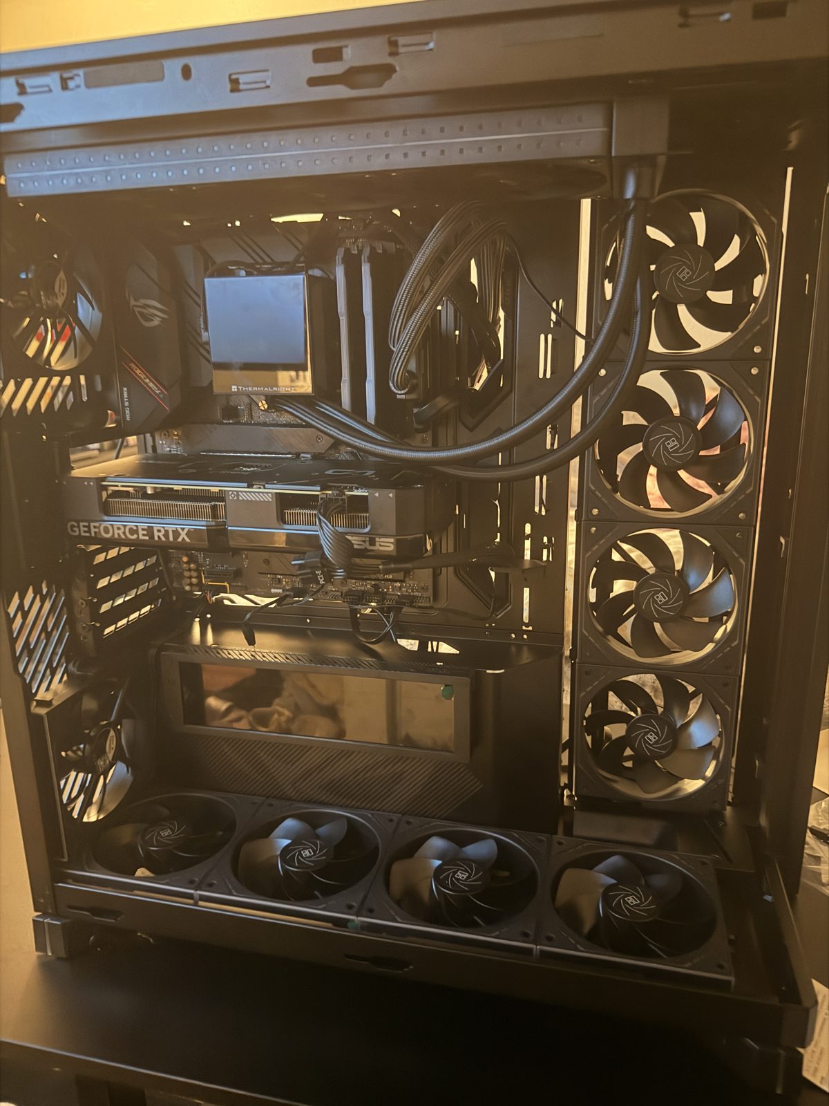 Interior of a recent custom PC build showing the graphics card, CPU AIO liquid cooler and case fans